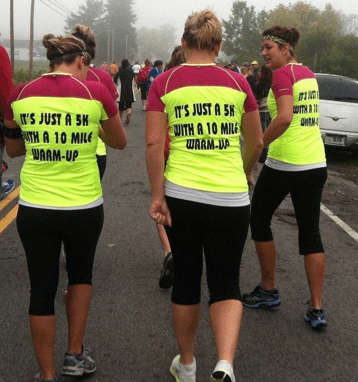 Runners wearing shirts saying "It's just a 5K with a 10 mile warm-up"